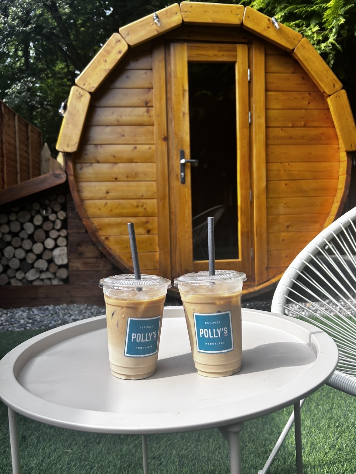 Polly's iced coffees on a table in front of the An Lasán barrel sauna